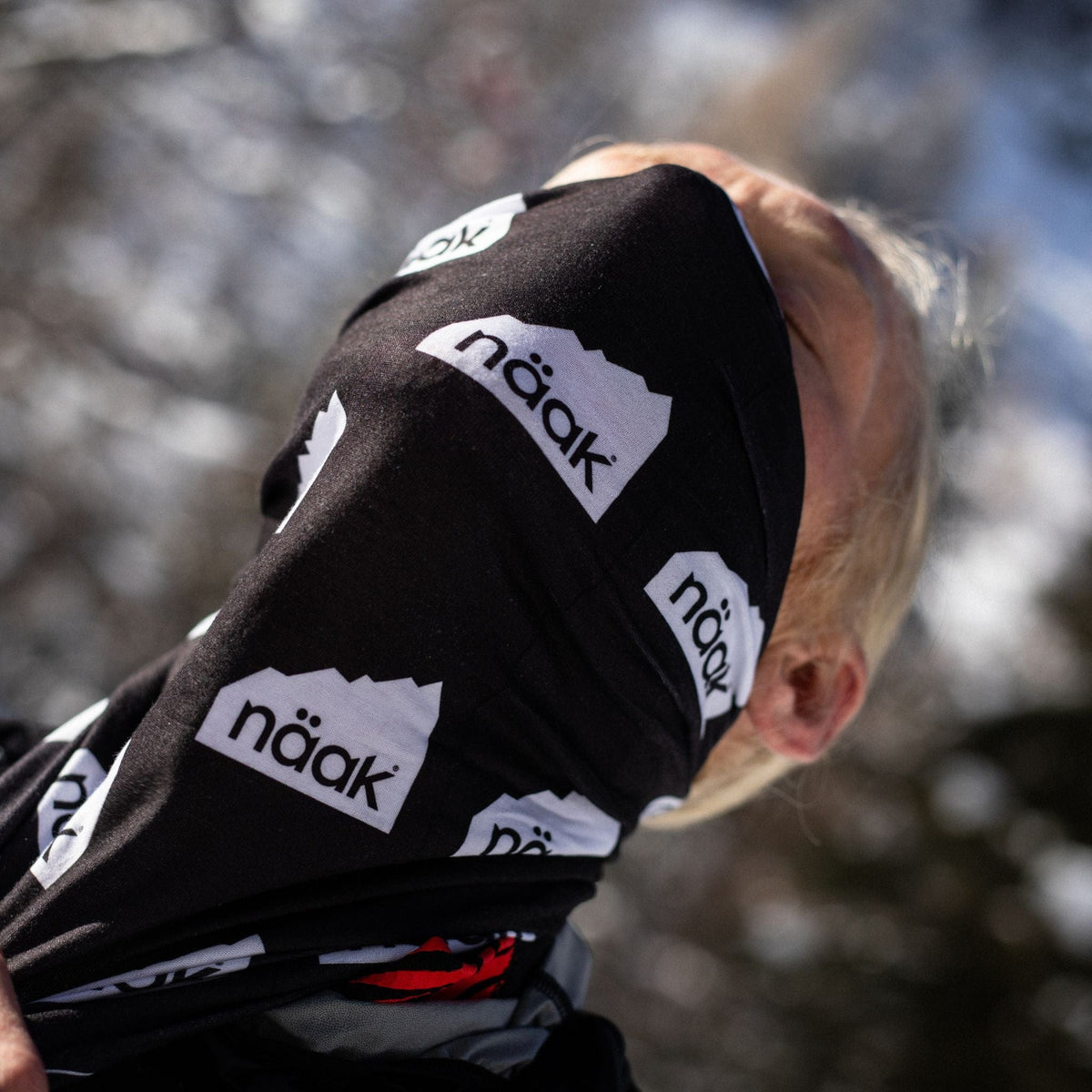 Male runner athlete wearing black and white naak neck buff from naak gear